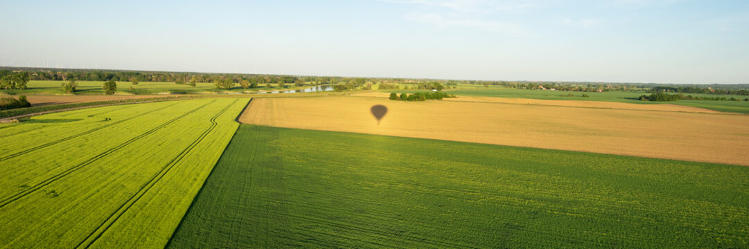 Hot air balloon shadow on the field. Panoramic image