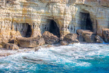 Beautiful scenic rocks in Cyprus caves and grottoes on the shores of the Mediterranean, a background with beautiful rock texture as a concept of travel and tourism travel