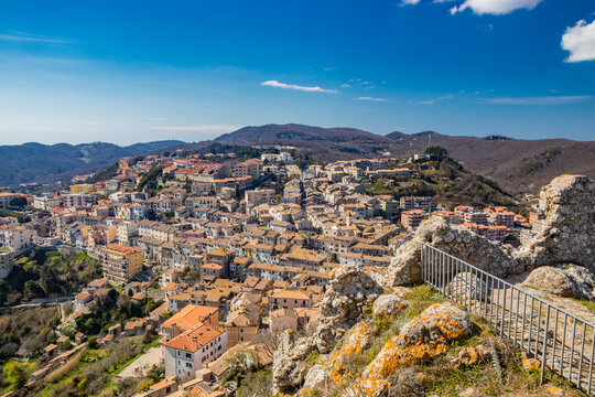 The small village of Tolfa, in Lazio. The view of the town perched on the mountain, from the top of the ruins of the castle walls. The roofs of the houses with red and orange tiles.