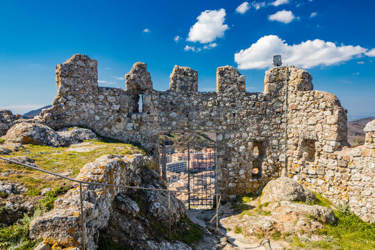The small village of Tolfa, in Lazio. The remains of the ancient walls of the fortress that stands on top of the cliff. The ruins of the castle and the houses of the town located downstream.