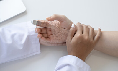 Doctor is looking at the patient's finger splint, finger straight with orthopedic device, Treatment...