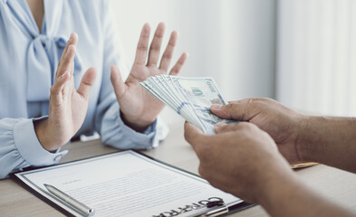 Businessmen give dollars to bribe employees in signing contracts to buy illegal land and real estate, Business fraud and social injustice, Anti Bribery and corruption concept.