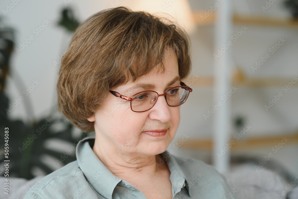 Sticker Closeup portrait of older woman wearing glasses.