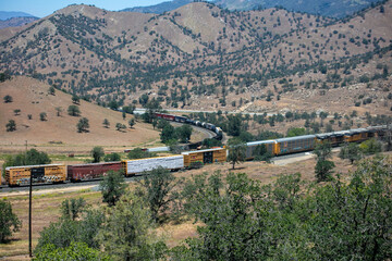 The Tehachapi Loop where Trains Cross over themselves to Climb a Steep Grade with 2 Trains Crossing together Time Lapse