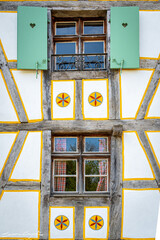 Simmetric windows of a traditional alsatian house in the Ecomuseum Alsace in city of Mulhouse,...