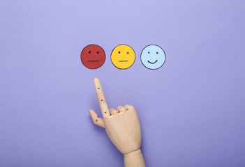 Bad service. Customer satisfaction survey concept. Hand chooses sad face icon, happy, neutral face...