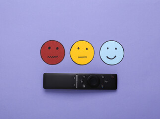 Customer satisfaction survey concept. Tv remote, Happy, neutral and sad face paper icon on violet background. Top view
