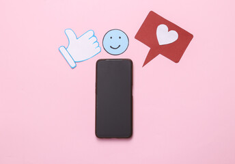 Paper cut social media notification icons with smartphone on pink background. Top view. Flat lay