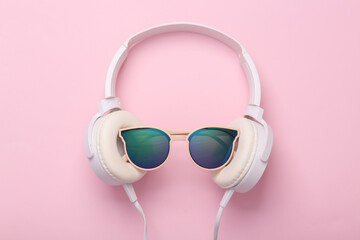 Creative minimal still life, Stereo headphones with sunglasses on a pink background. Youth, hipster...