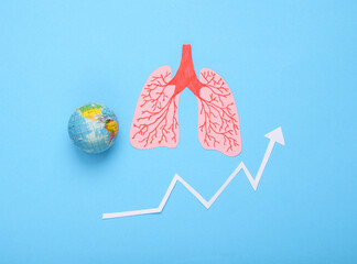 Covid 19 pandemic, disease statistics. Anatomical lungs with globe and growth arrow on blue background