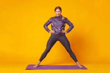 Fototapeta na wymiar Sport woman trainin on yellow studio background