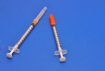 Insulin syringe and 1cc syringe used for intra-dermal injections and test doses.image isolated on a blue background