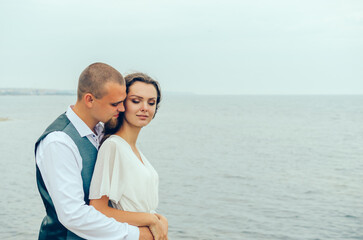 husband and wife hugging by the sea. Honeymoon.