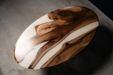 large oval family table made of natural wood and white epoxy