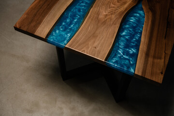 handmade table made of natural solid wood and blue epoxy resin