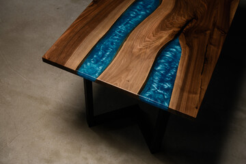 expensive table made of natural solid wood and blue epoxy