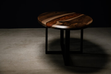 dark photo of a table made of natural wood and epoxy