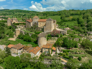 Fototapeta na wymiar Aerial view of imposing castle of Berze Le Chatel in Burgundy with 14 towers and three enclosures in Central France dominating the valley below