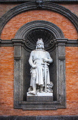 Fototapeta na wymiar Statue King Friedrich II on the facade of Palazzo Reale di Napoli in Piazza del Plebiscito in Naples