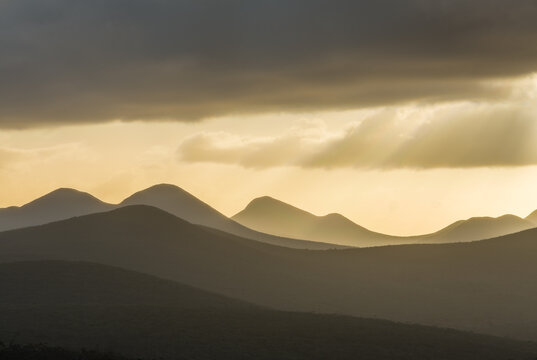Sunset over mountains; silhouettes of hills and ridges in backlight n the the Stirling Range, Western Australia