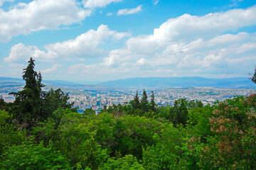 Fototapeta na wymiar view from top above on the city, aerial observation, forest in front of town, cloudy sky