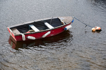 Old boat derelict on shore at Loch Lomond
