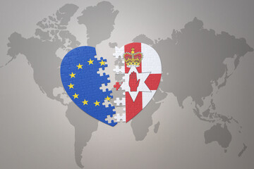 puzzle heart with the national flag of european union and northern ireland on a world map background. Concept.