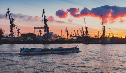 Passenger ferry sails at port of Hamburg on a sunset