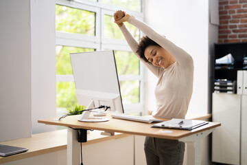 Worker Stretch Exercise At Stand Desk