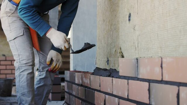 close-up bricklaying, builder's hands, footage of construction