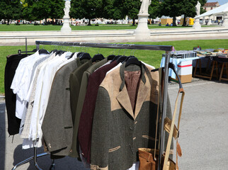 flea market in the public park and the coats and jackets and shirts and other clothes used in the...