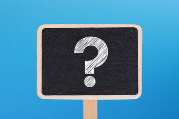 Question mark design on chalkboard with blue background