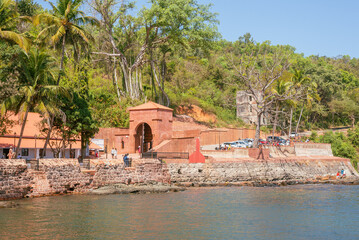 Renovated Aguada Central Jail and Fort Exteriors and facade and landscape with the blue ocean in background - obrazy, fototapety, plakaty