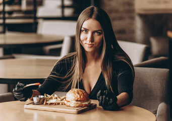 Woman eating burger. Woman have lunch at fast food restaurant