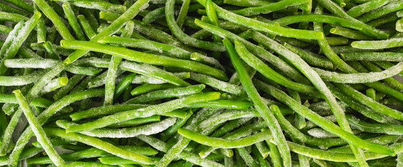Frozen green beans, haricots verts, close up from above. Fresh raw vegetable food background