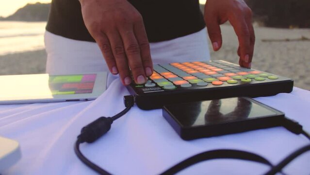 Latin man using midi. music on the beach music session