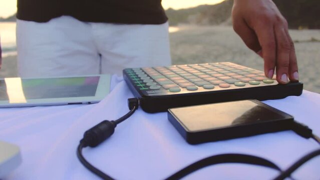 Latin man using midi. music on the beach music session