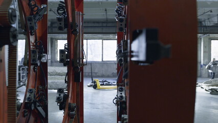 Closeup robotic tire machine moving at modern automotive workhouse facility