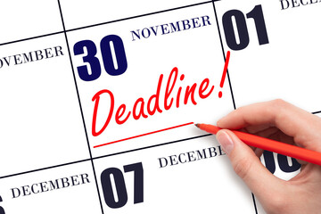 Hand drawing red line and writing the text Deadline on calendar date November 30. Deadline word written on calendar