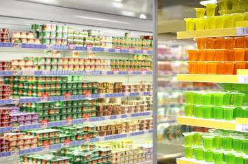 choosing a dairy products at supermarket.empty grocery cart in an empty supermarket