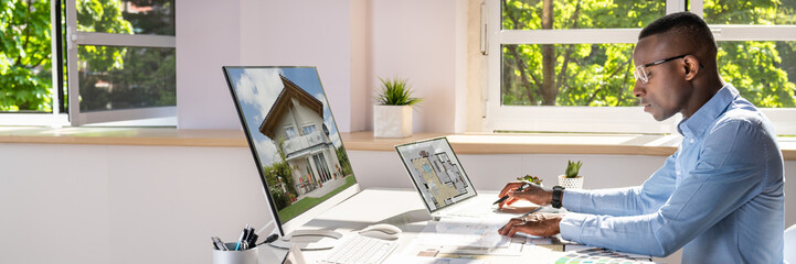Real Estate Designer Working On Computer