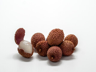 Several lychee fruits, one with open peel