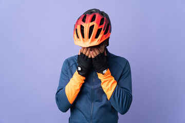 Young Moroccan cyclist man isolated on purple background with tired and sick expression - obrazy, fototapety, plakaty