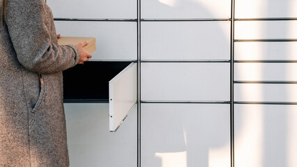 Postal terminal. Post delivery automat service and hands with parcel courier box. Mail delivery and post service concept.