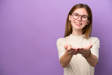 Young English woman isolated on purple background holding copyspace imaginary on the palm to insert...