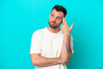 Young Brazilian man isolated on blue background with problems making suicide gesture