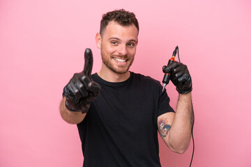 Tattoo artist brazilian man isolated on pink background showing and lifting a finger