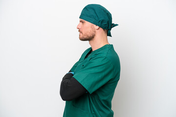 Surgeon Brazilian man in green uniform isolated on white background in lateral position