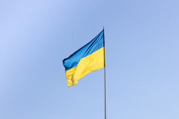 The state flag of Ukraine on a background of blue sky