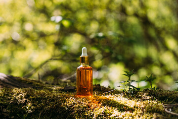 bottle mockup with dropper on nature background.